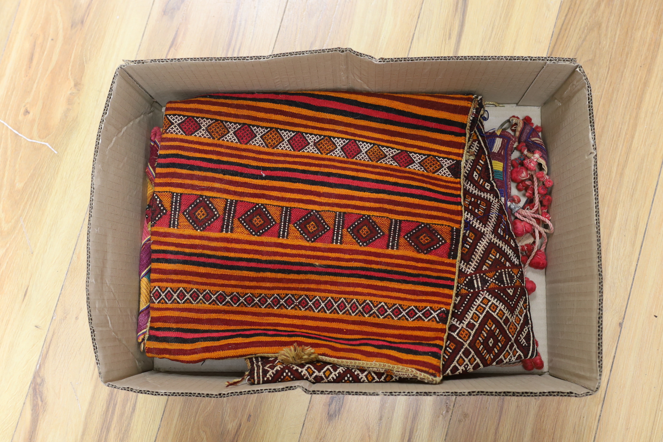 Two late 19th early 20th century Kohistani embroidered bags and a woven cushion cover/bag and a silk embroidered Banjara bag (a.f.), cushion cover 69cm wide x 31cm long